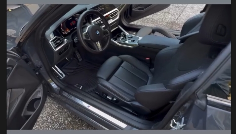 Clean black leather front interior of a BMW after an interior detail in Milton